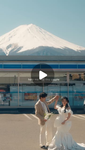 A couple framed beneath Mount Fuji in a cinematic vertical composition